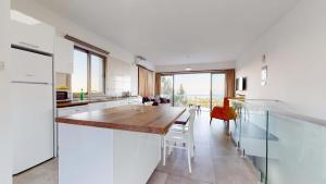 a kitchen and dining room with a long wooden table at Villa Cypress Villas in Kyrenia