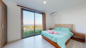 a bedroom with a bed and a large window at Villa Cypress Villas in Kyrenia