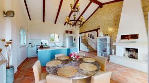 a kitchen with a table and chairs and a fireplace at Villa Ambiance in Kyrenia