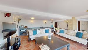 a living room with two white couches and a table at Villa Ambiance in Kyrenia