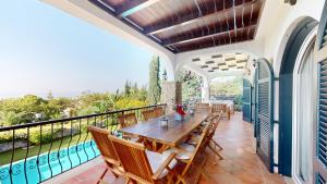 a dining room with a table and chairs on a balcony at Villa Ambiance in Kyrenia