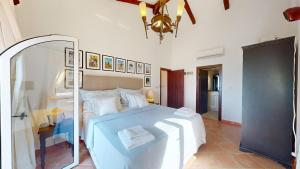 a bedroom with a large white bed and a mirror at Villa Ambiance in Kyrenia +13 photos
