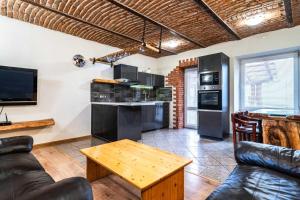 a living room with a couch and a table at Apartman Kamzik - 2 in Veľká Lomnica