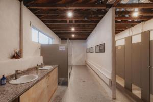 a large bathroom with two sinks and a window at Cosy yurt at a nature retreat in CA in Miramonte