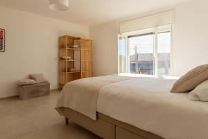 a bedroom with a large bed and a window at Casa all'angolo in Rocchetta Tanaro