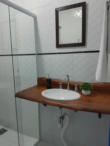 a bathroom with a sink and a mirror at Recanto dos Açores in Florianópolis +31 photos