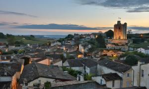 a view of a town with a clock tower at Chambre d'Hotes La Roseraie in Parsac