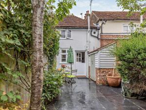 a house with a patio in the rain at 1 Bed in Tenterden oc-66342 in Tenterden