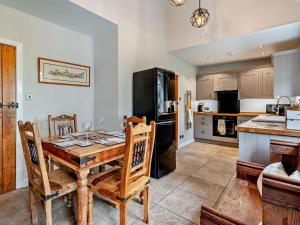 a kitchen with a wooden table and chairs in a room at 2 Bed in Mindrum oc-50973 in Crookham