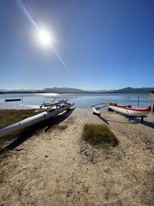 a boat tied up on the shore of a lake at Casa Canoa in Imbituba