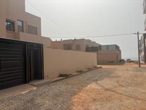a building with a black door on the side of it at Ber appartement in Mirleft