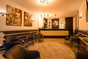 a salon with chairs and a waiting room with a table at City Hotel Mercator in Frankfurt