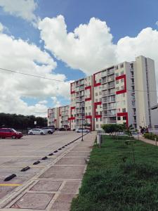 a parking lot with a large apartment building at APARTAMENTO RICAURTE Cund in Ricaurte