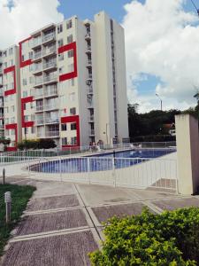 a building with a pool in front of a building at APARTAMENTO RICAURTE Cund in Ricaurte