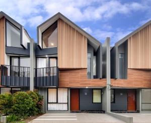 an exterior view of a building with wood at Trevista With Private Pool in Curug 1