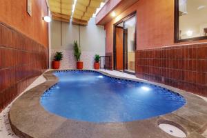 an indoor pool in a building with blue water at Trevista With Private Pool in Curug 1