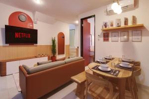 a living room with a couch and a table at Trevista With Private Pool in Curug 1