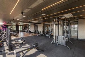 a gym with several treadmills and machines at Sky Design Residence in Barueri