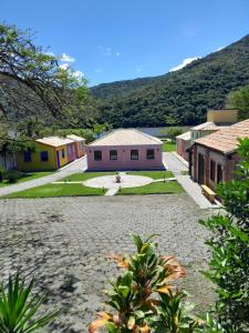 a group of houses with mountains in the background at Recanto dos Açores in Florianópolis
