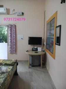 a room with a desk with a computer on it at Manvitha Homestay in New Hampi