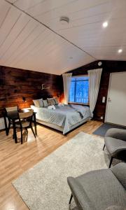 a bedroom with a bed and a table and chairs at North Frontier Cabins in Saariselka
