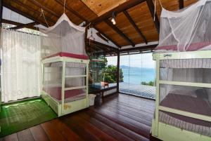 two bunk beds in a room with a balcony at Hostel do Morro in Florianópolis