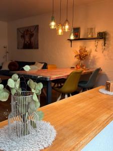 a living room with a table with a vase on it at Haus Porsche in Hellenthal
