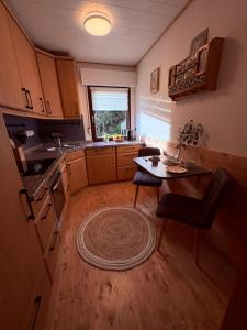 a small kitchen with a table and a table sidx sidx sidx at Haus Porsche in Hellenthal