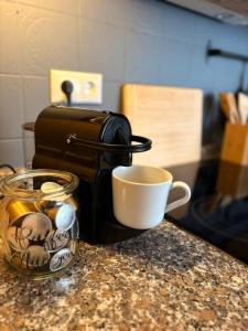 a coffee maker and a cup on a counter at Haus Porsche in Hellenthal +26 photos