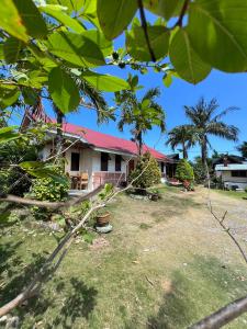 una casa con il tetto rosso e un cortile di D Mountain Beach Resort a Puerto Galera