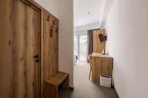 a room with a hallway with a door and a desk at Casa Piattino in Kvasy