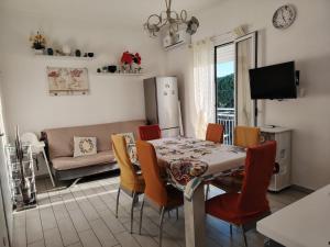 a kitchen and dining room with a table and chairs at La casa di San Pio X in Agrigento