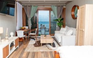 a living room with a couch and a table at Cozy studio, beach and pool access with sea view in Marigot