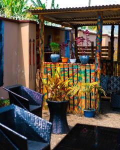 a group of chairs and potted plants in a patio at Mango Hostel Arusha in Arusha