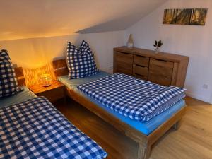 a room with two beds and a dresser at Schneekopfblick in Oberhof +3 photos
