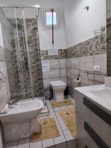 a bathroom with a toilet and a sink and a shower at La casa di San Pio X in Agrigento +28 photos