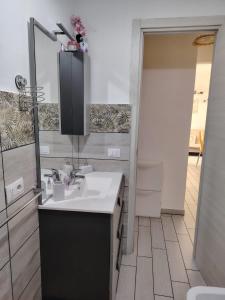 a bathroom with a sink and a mirror at La casa di San Pio X in Agrigento