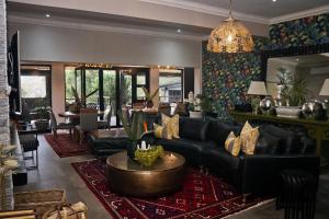 a living room with a couch and a table at Peggie's Boutique Hotel in King Williamʼs Town