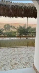 a view of a patio with an umbrella at شاليهات ليوا in Al Mashrūb