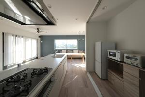 a kitchen with a stove and a refrigerator at THE POOL HOUSE Kisarazu in Kisarazu +42 photos