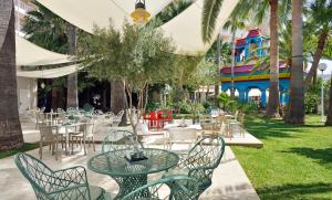 a patio with tables and chairs in a park at Sol Katmandu Park & Resort in Magaluf
