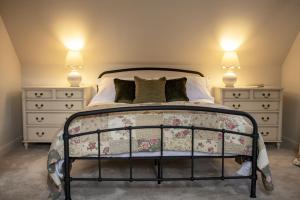 a bedroom with a large bed with two dressers at Lark Rise in Boltby