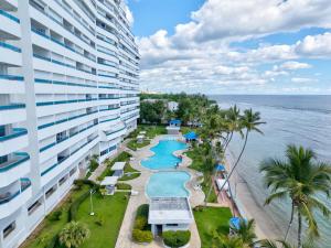 an aerial view of a hotel and the ocean at Las Olas, Juan Dolio 2bed2bath Condo in Guayacanes