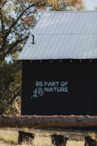 a sign that says be part of nature at Glamping yurt at a nature retreat Sequoia Highland in Miramonte