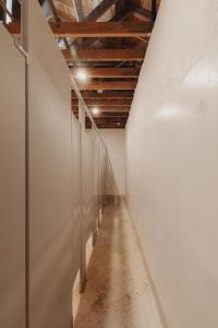 a long hallway with white walls and a wooden ceiling at Glamping yurt at a nature retreat Sequoia Highland in Miramonte