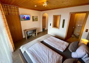 a bedroom with a bed and a desk in it at Hotel-Gasthof Lammersdorf in Millstatt