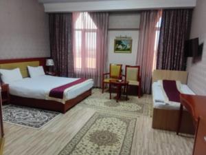 Postel nebo postele na pokoji v ubytování Shane Hotel