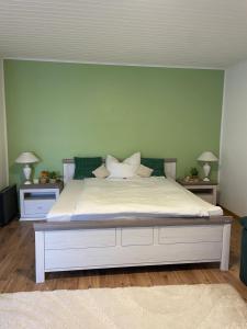 a bedroom with a large white bed with two night stands at Ferienwohnung Kaltenegger in Gaal
