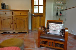a living room with a chair and a cabinet at Les Mourguettes in La Celle-sous-Gouzon