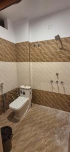 a bathroom with a toilet and a shower at Hotel Shyam Villa in Ayodhya